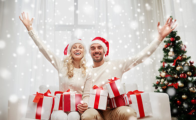 Image showing happy couple at home with christmas gift boxes