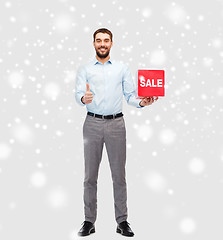 Image showing smiling man with red shopping bag