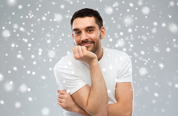 Image showing smiling man over snow background