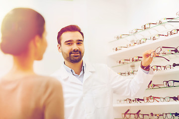 Image showing woman and optician showing glasses at optics store