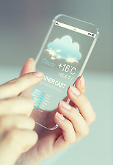 Image showing close up of hands with weather cast on smartphone