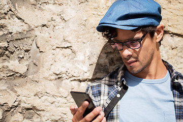 Image showing hipster man texting message on smartphone