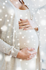 Image showing close up of pregnant woman belly and hands