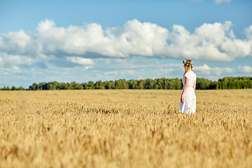 Image showing happy young woman in flower wreath on cereal field