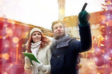 Image showing happy couple walking with tablet pc in old town