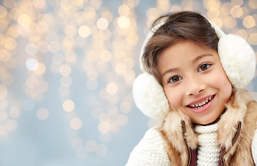 Image showing happy little girl wearing earmuffs