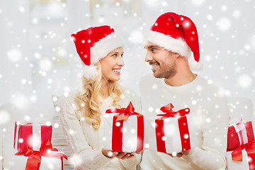 Image showing happy couple at home exchanging christmas gifts