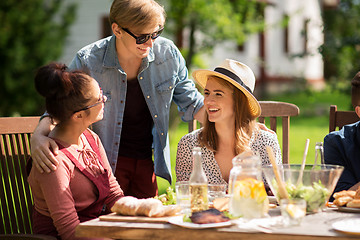 Image showing happy friends having dinner at summer garden party