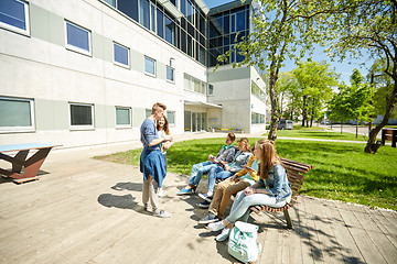 Image showing teenage students with tablet pc at school yard