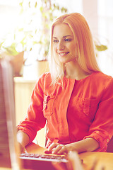 Image showing happy business woman with computer at office