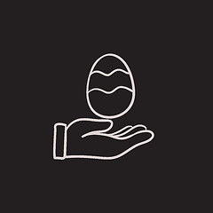 Image showing Hand holding easter egg sketch icon.