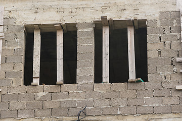 Image showing Wooden braces put in the window opening when building a house