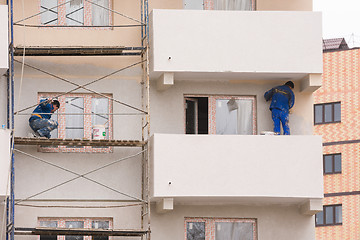 Image showing Anapa, Russia - November 16, 2016: The workers perform the finishing and painting the facade of high-rise buildings