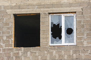 Image showing Anapa, Russia - November 16, 2016: Two windows in an unfinished house - one without a frame and glass, the other broken glass