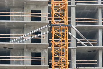 Image showing Mounting construction crane lifting to overlaps in the construction of the house