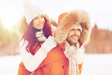 Image showing happy couple having fun over winter background