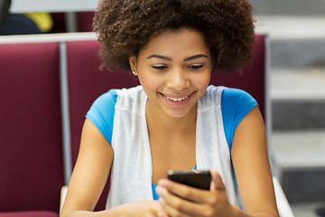 Image showing african student girl with smartphone on lecture