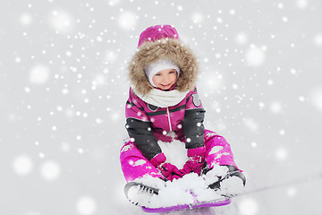 Image showing happy little kid on sled outdoors in winter