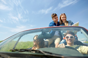 Image showing happy friends with map driving in cabriolet car