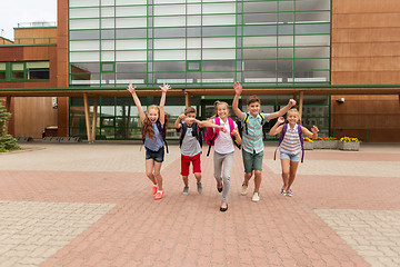 Image showing group of happy elementary school students running