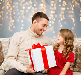 Image showing smiling father and daughter with christmas gift