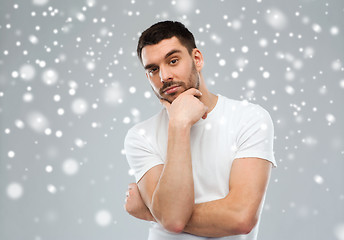 Image showing man thinking over snow background