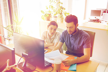 Image showing creative team with computer and papers in office