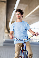 Image showing young hipster man riding fixed gear bike