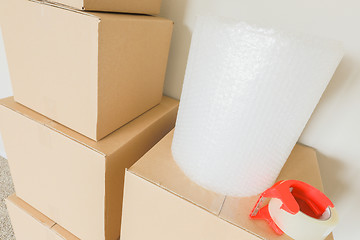 Image showing Variety of Packed Moving Boxes In Empty Room