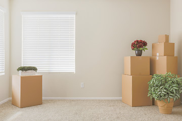 Image showing Variety of Packed Moving Boxes In Empty Room