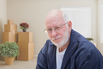 Image showing Senior Man in Empty Room with Packed Moving Boxes