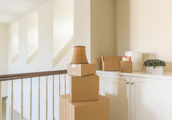 Image showing Variety of Packed Moving Boxes In Empty Room