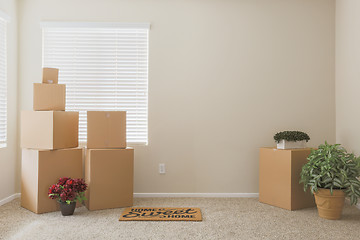 Image showing Variety of Packed Moving Boxes In Empty Room