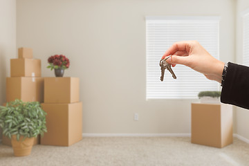 Image showing Handing Over House Keys In Room with Packed Moving Boxes