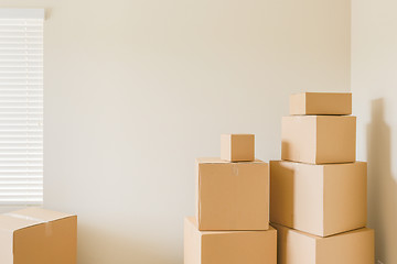 Image showing Variety of Packed Moving Boxes In Empty Room