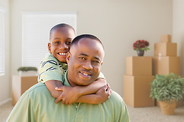 Image showing African American Father and Son In Room with Packed Moving Boxes