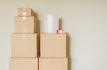 Image showing Variety of Packed Moving Boxes In Empty Room