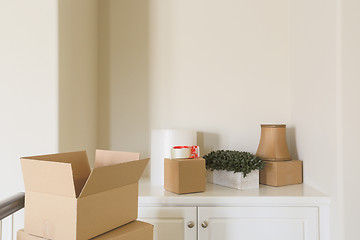 Image showing Variety of Packed Moving Boxes In Empty Room