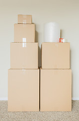 Image showing Variety of Packed Moving Boxes In Empty Room