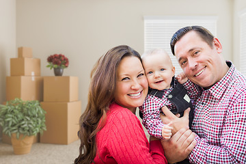 Image showing Caucasian Family with Baby In Room with Moving Boxes