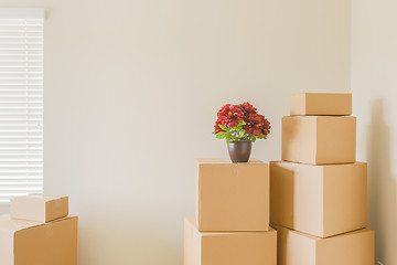 Image showing Variety of Packed Moving Boxes In Empty Room