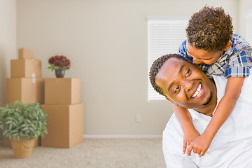 Image showing Mixed Race African American Father and Son In Room with Packed M