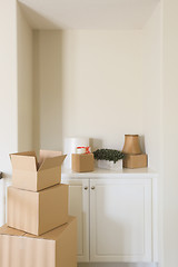 Image showing Variety of Packed Moving Boxes In Empty Room