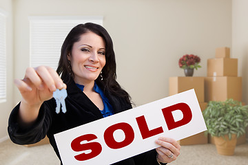 Image showing Hispanic Female Real Estate Agent with Sold Sign and Keys in Roo