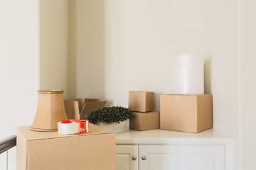 Image showing Variety of Packed Moving Boxes In Empty Room