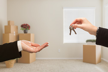 Image showing Handing Over House Keys In Room with Packed Moving Boxes