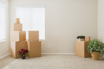 Image showing Variety of Packed Moving Boxes In Empty Room