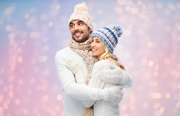 Image showing smiling couple in winter clothes hugging