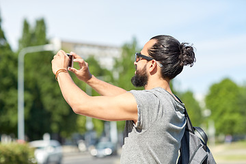 Image showing hipster man taking picture on smartphone