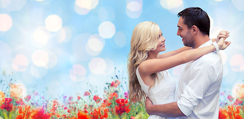 Image showing happy couple hugging over natural background
